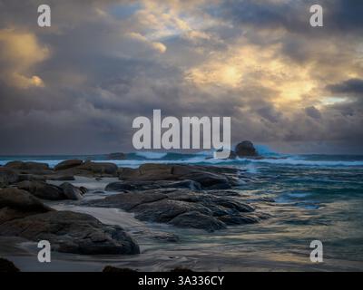 Stormy sunset and crashing waves at Redgate Bay, Western Australia Stock Photo