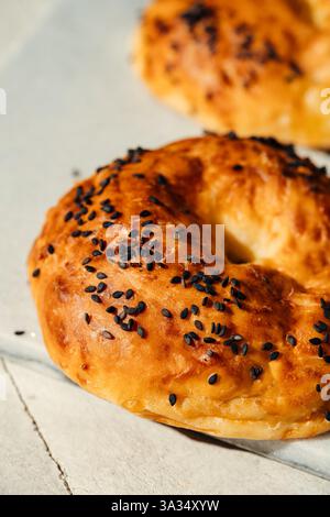 A close-up image of freshly baked bagels topped with sesame seeds. The golden-brown crust and soft texture make them an appetizing choice for any brea Stock Photo