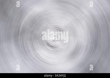 A distorted photograph showcasing an abstract spiral pattern in monochrome. The concentric circles create a sense of motion and depth, invoking a surr Stock Photo