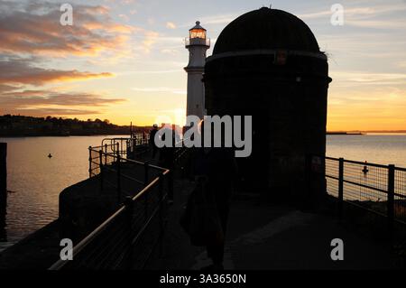 Silhouette of lighthouse at sunset in Edinburg harbour Stock Photo