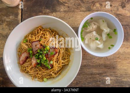 a meal of wonton noodles and a bowl of wonton soup. Wonton noodles are a Cantonese dish featuring egg noodles, wontons, Nanyang Cafe, Johor Bahru Stock Photo