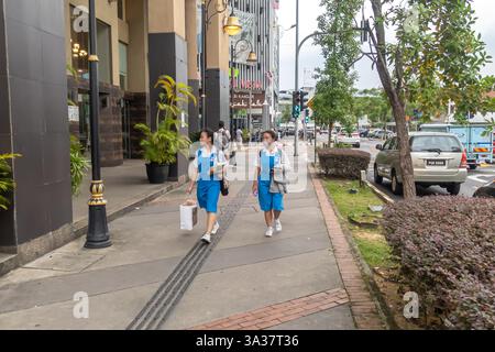 Female students in uniform in the street, Kuala Lumpur Malaysia Stock Photo