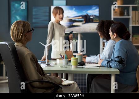 Woman Making Notes During Presentation Stock Photo
