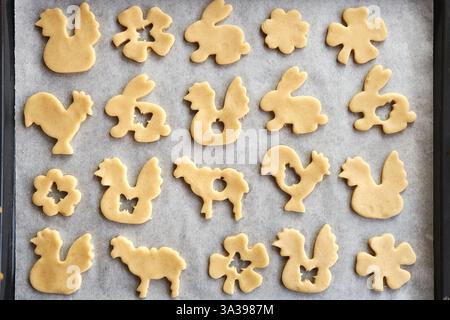 Animal shaped Linzer Easter cookies on a baking sheet, top view Stock Photo