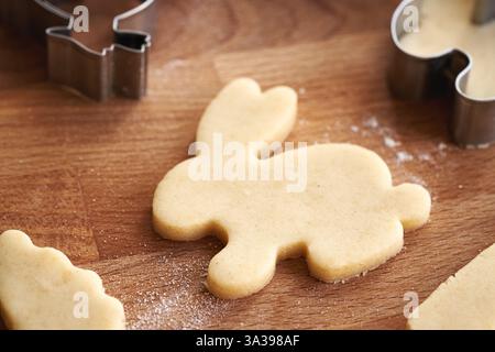 Bunny shape cut out from raw pastry dough - preparation of Linzer Easter cookies Stock Photo