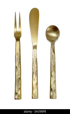 Golden fork, knife, and spoon with textured handles arranged on a white background, creating a visually appealing culinary composition Stock Photo