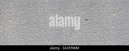 Close-up view of a gray concrete wall, highlighting its rough and textured surface Stock Photo