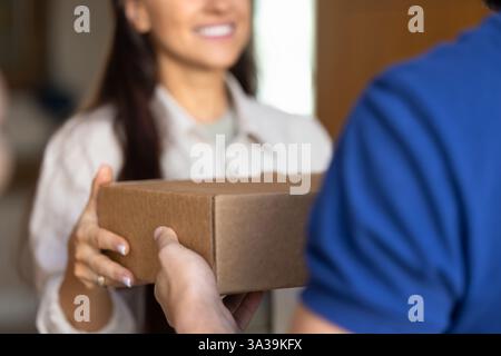 Female customer taking parcel from delivery logistic service worker man Stock Photo
