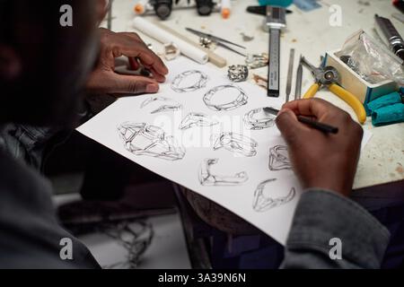 Serious elder engineer in work helmet using digital tablet to control the work on factory Stock Photo