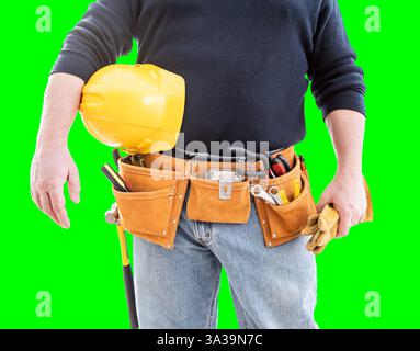 Front Partial View of Construction Worker Wearing Tool Belt and Holding Hard Hat and Gloves on Green Screen Stock Photo