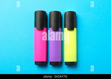 Bright highlighters on light blue background, flat lay Stock Photo