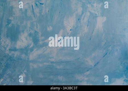The wall surface is painted bright blue with abstract shapes and colors. Stock Photo