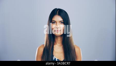 Portrait, serious and student with woman in studio for development, education or learning. College, scholarship and university with confident learner Stock Photo