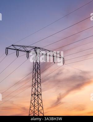 Poles with high-voltage wires against the sky Stock Photo - Alamy