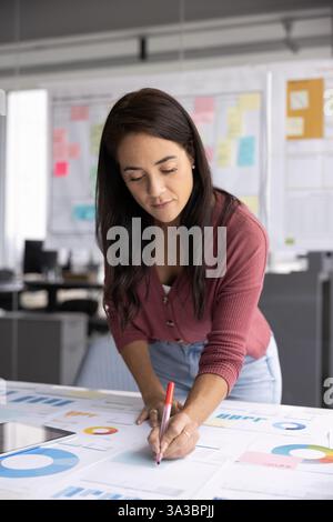 Focused busy young company manager woman working on project Stock Photo