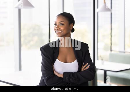 Successful African businesswoman looking into distance with positive expression Stock Photo