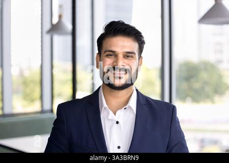 Young Indian male project leader posing in modern coworking office Stock Photo