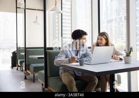 Two employees working together in modern coworking office Stock Photo