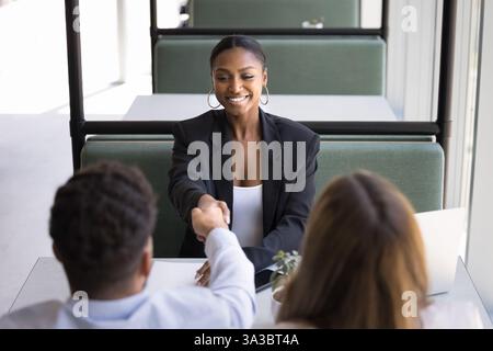 African woman applicant greeting HR manager start job interview Stock Photo