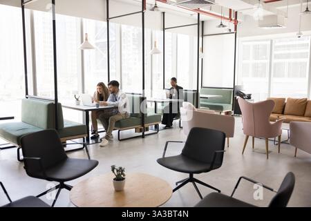 People working in modern, open-space co-working area Stock Photo