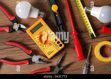 Different electrical tools on wooden table, flat lay Stock Photo