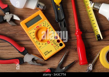 Different electrical tools on wooden table, flat lay Stock Photo
