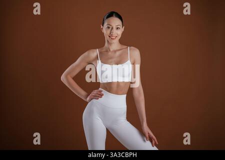 Front view. Beautiful fitness woman is in the studio. Stock Photo