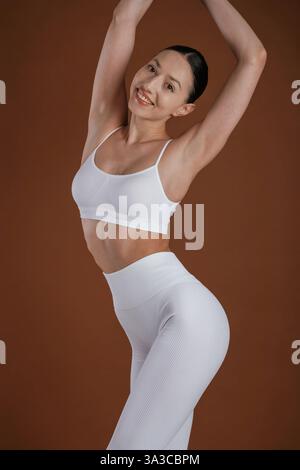 Front view. Beautiful fitness woman is in the studio. Stock Photo