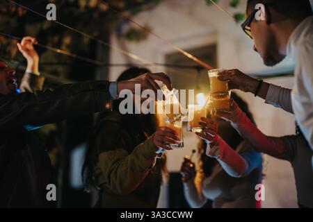 Friends raising glasses at a birthday celebration during a vibrant evening gathering Stock Photo