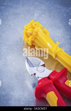 Wire-cutter plastic self-locking cable ties on metallic background construction concept Stock Photo