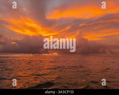 Beautiful sunset over sea. Colorful dramatic majestic scenery sunset sky. Amazing clouds and small waves in the ocean Stock Photo