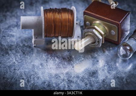 Vintage electric toggle switch transformer lamp-holder on scratched metallic background Stock Photo