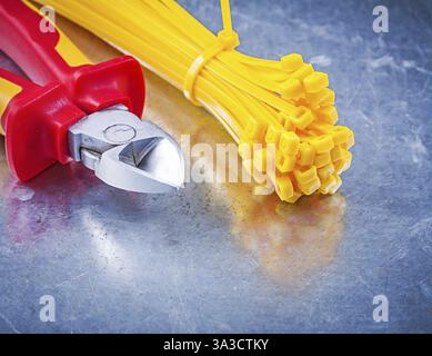 Wire-cutter plastic cable ties on metallic background construction concept Stock Photo