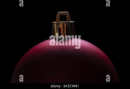 Very close up view on big red christmas bauble isolated on black background Stock Photo