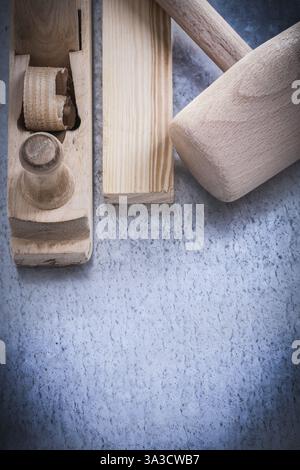Wooden shaving plane hammer stud on metallic background construction concept Stock Photo
