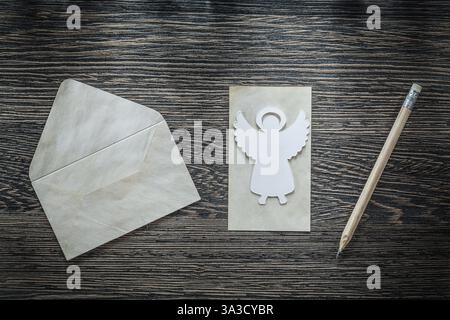 Vintage envelope paper angel pencil on black board Stock Photo