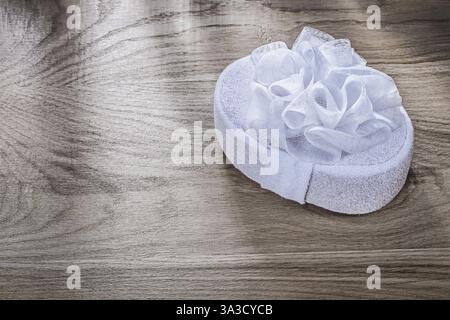 White bath sponge on wooden board bathing items concept Stock Photo