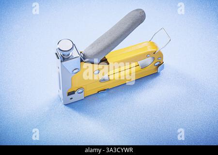 Construction stapler on blue background horizontal view Stock Photo - Alamy