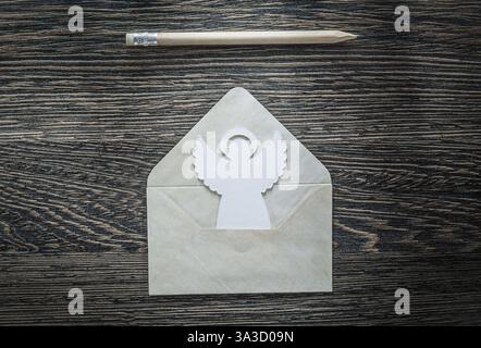 Vintage envelope angel pencil on black board top view Stock Photo