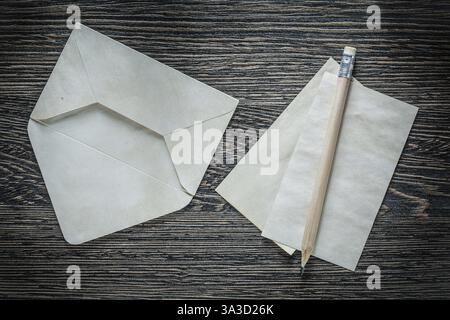 Vintage envelope blank paper sheet pencil on black board Stock Photo