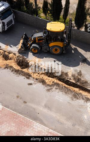 Heavy excavator machinery is actively digging into ground at ...