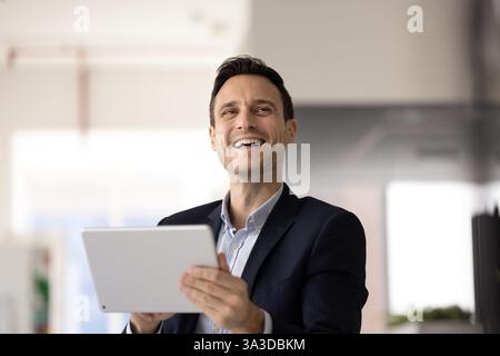 Happy business executive man using digital tablet for work Stock Photo