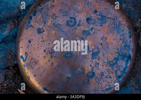 Circular Copper Plate on a Rough Wooden Surface. Design Background. Copy Space. Stock Photo
