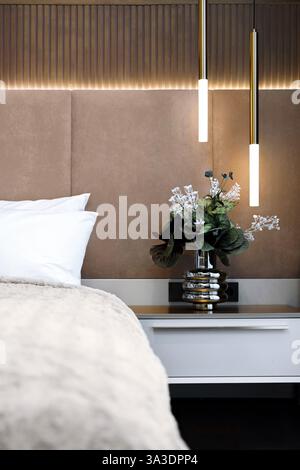 Modern bedroom decor with plants and stylish pendant lights. High quality photo Stock Photo
