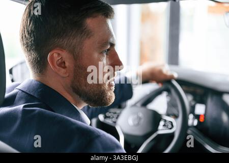Businessman is in the brand new car. Stock Photo