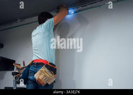The worker adjusts a metal frame, ensuring every bolt is tighten Stock Photo