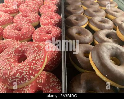 Lots of coloutful doughnuts for sale Stock Photo