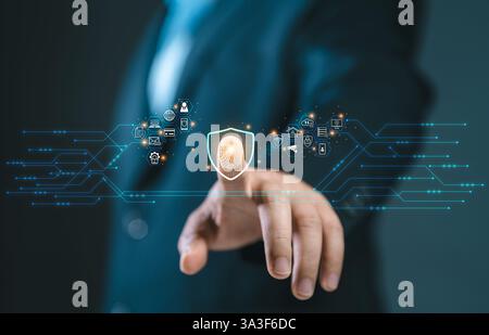 Cybersecurity and privacy concepts to protect data. Business Finger press on the fingerprint icon and internet network security technology. Virtual sc Stock Photo