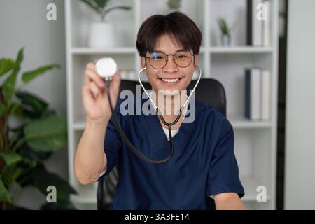Healthcare Tools and Professionalism. A smiling medical student showcases a stethoscope, representing readiness for a healthcare career. Stock Photo