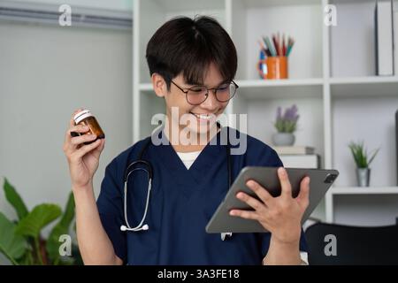 Engagement and Learning. A medical student smiling while using a tablet for medication management. Stock Photo